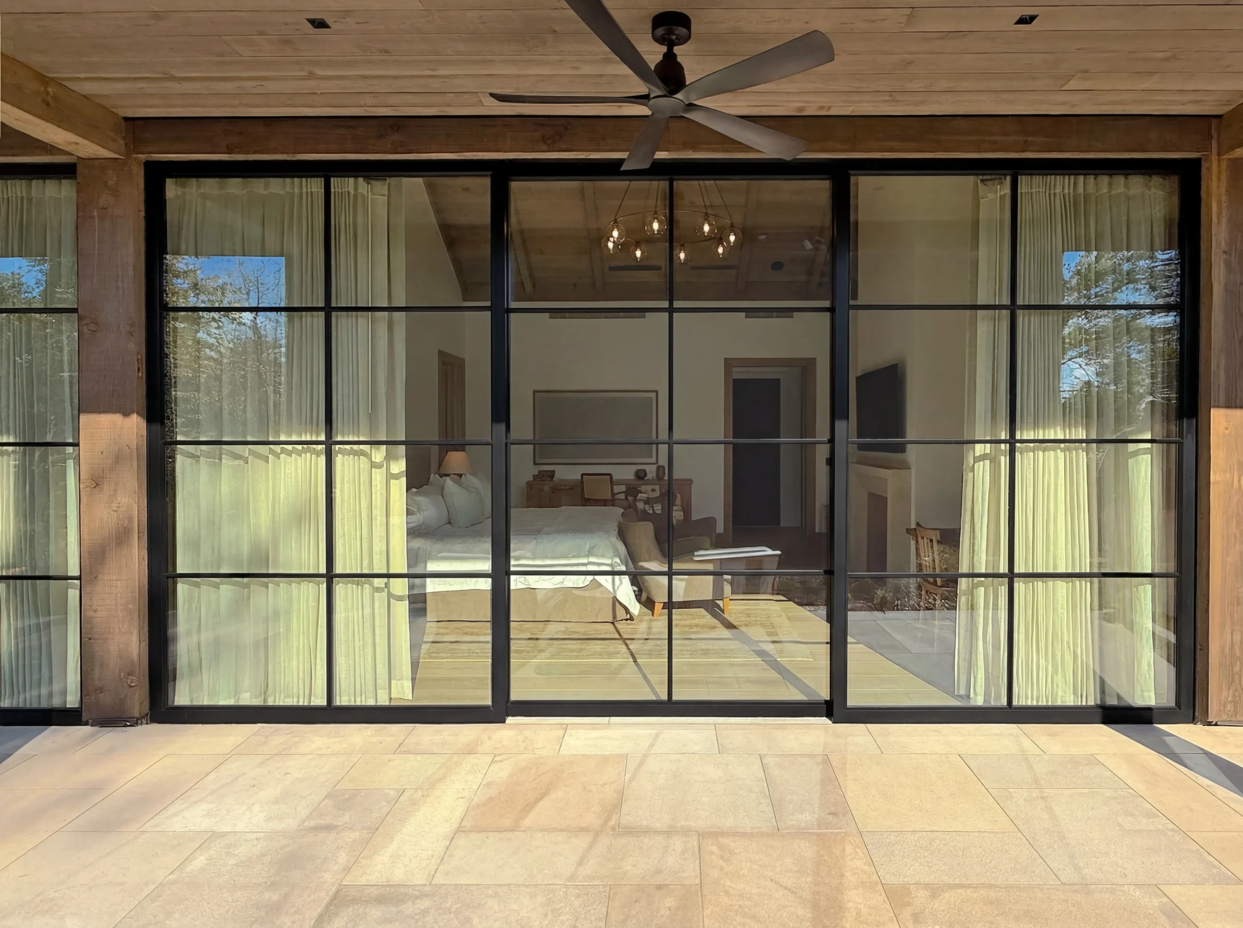 Thermal Steel sliding doors with powder coat finish, SDL muntins, low profile bottom track, high performance low iron insulating glass