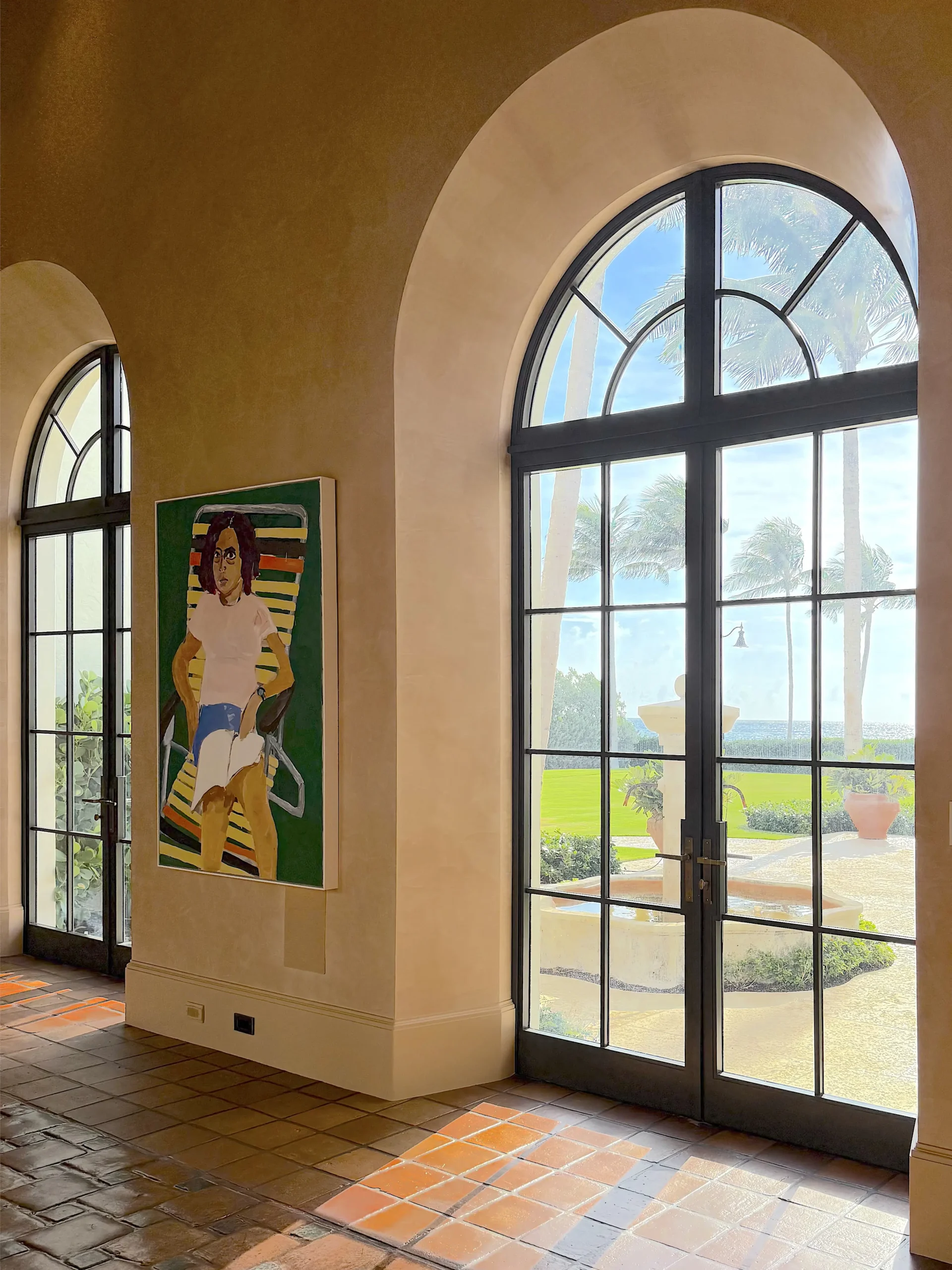 Thermal Stainless Steel Impact French door pairs with arched transoms, powder coat finish, SDL muntins, urricane rated glazing