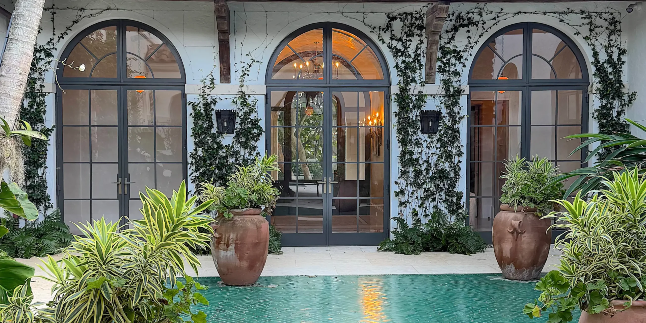 Thermal Stainless Steel Impact French door pairs with arched transoms, powder coat finish, SDL muntins, hurricane rated glazing